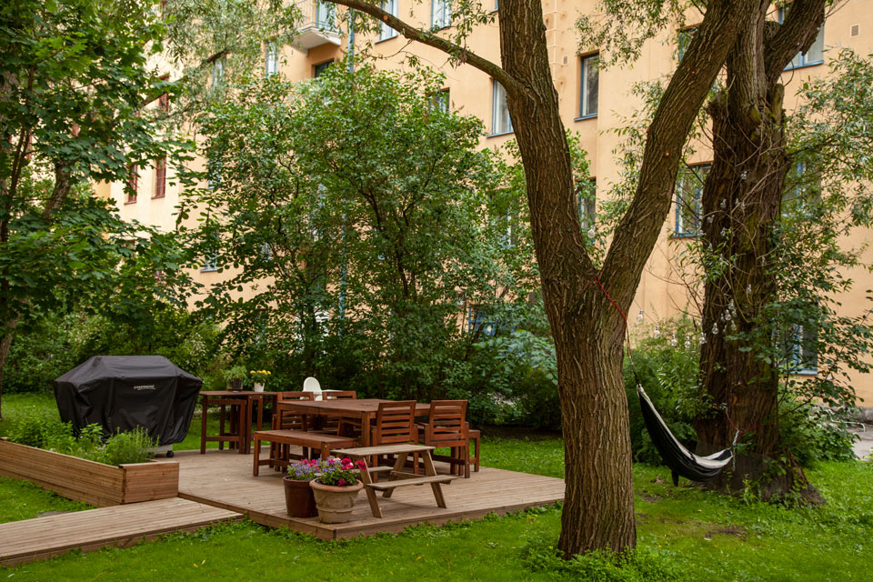 A barbecue patio and hammock in a green courtyard